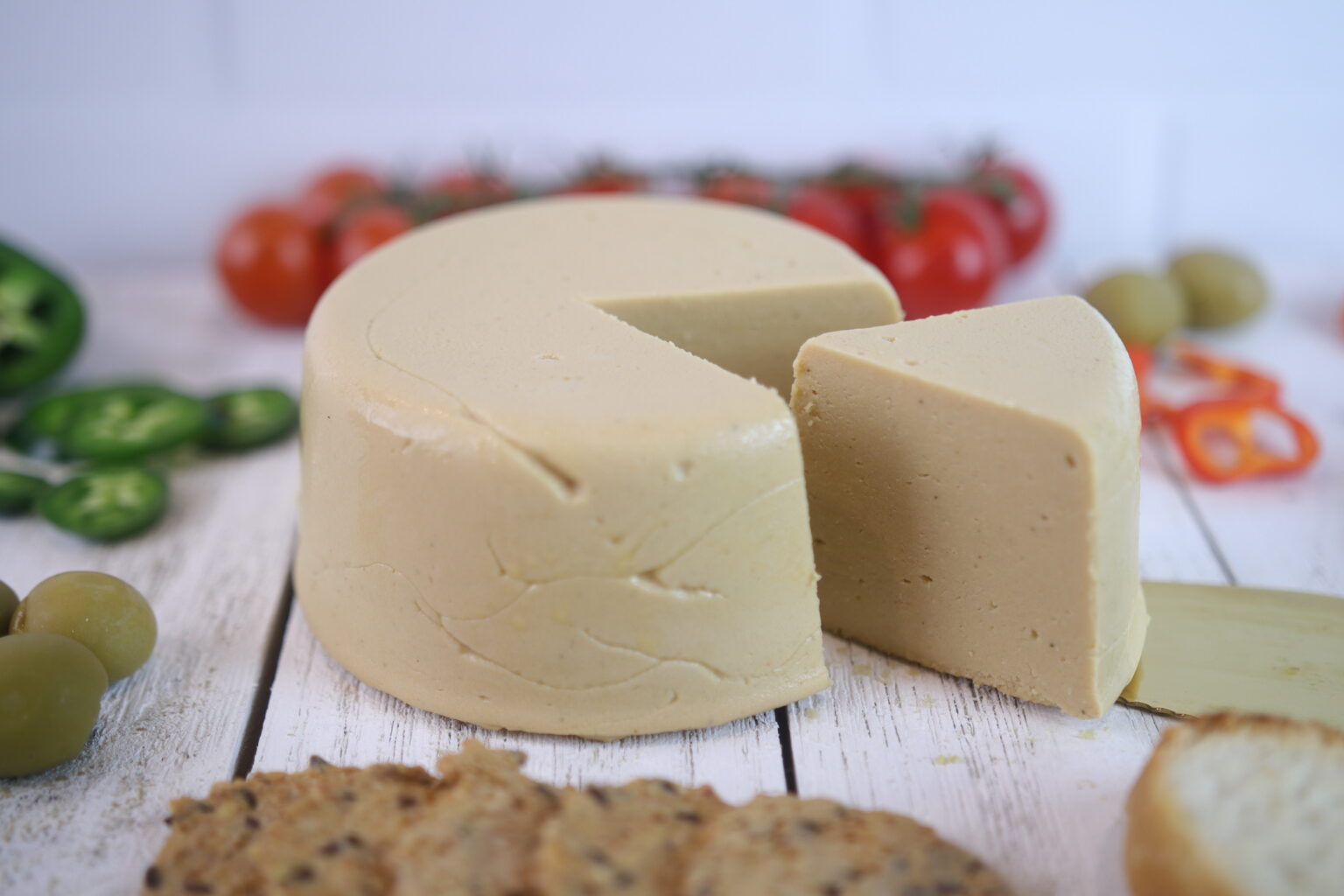 Vegan gouda wheel with tomatoes